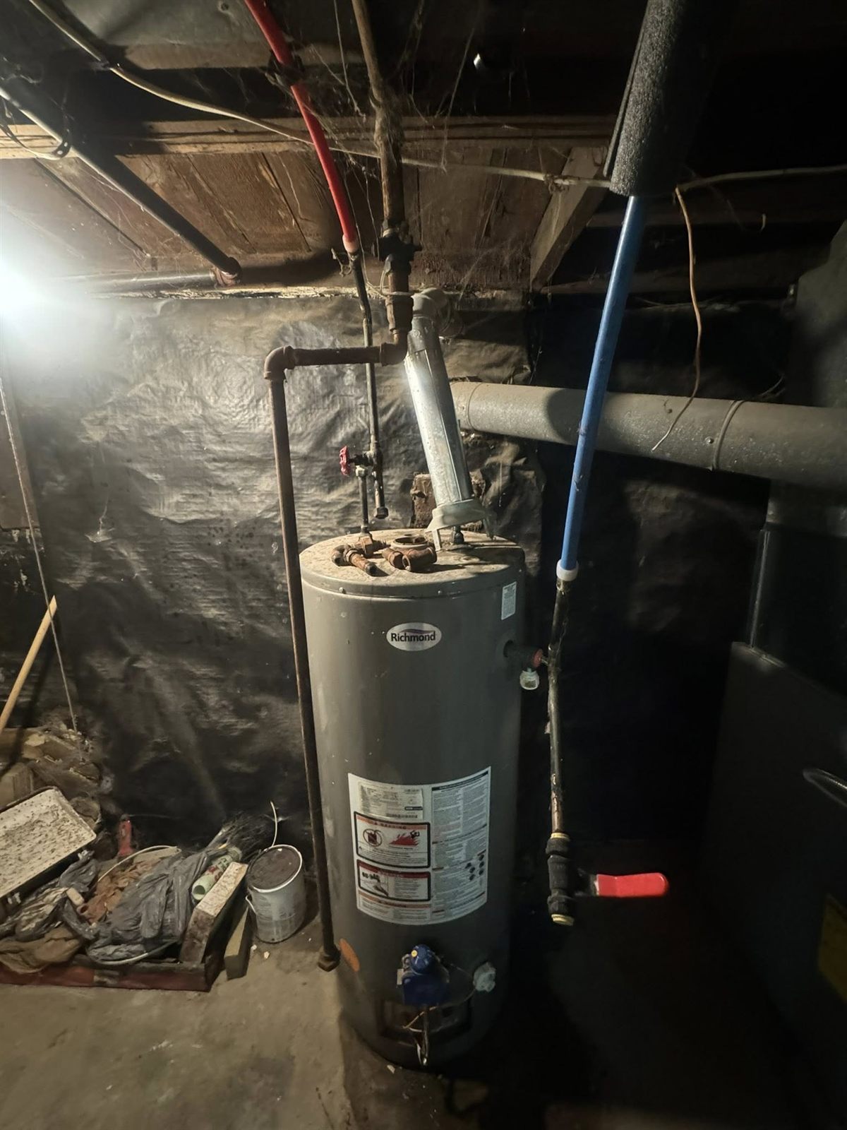 Water heater installation — new unit in place, connections complete